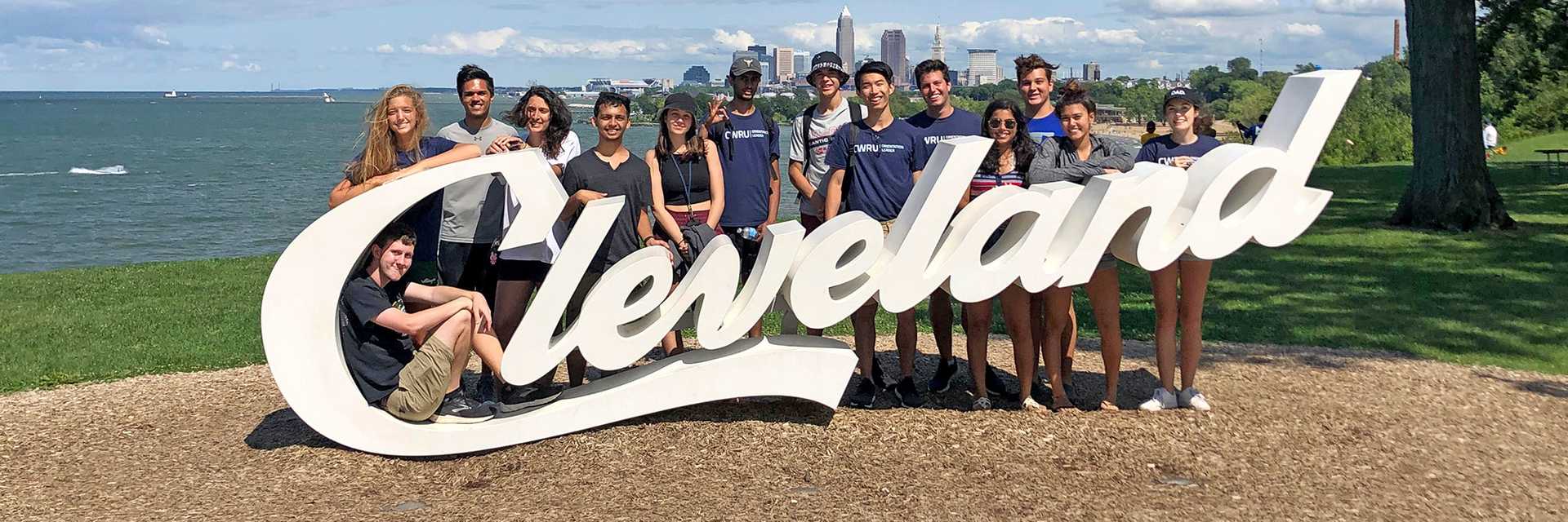 Photo of a Case Western Reserve University student walking across Mather Quad with prominent sun rays shining down